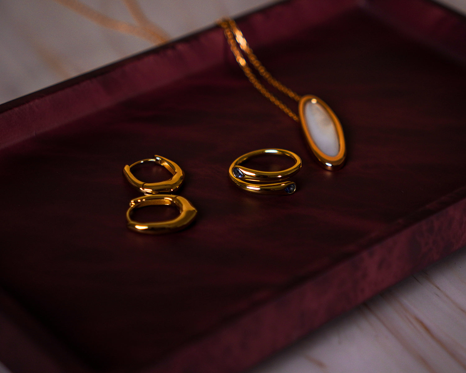 Gold rings on a dark red surface